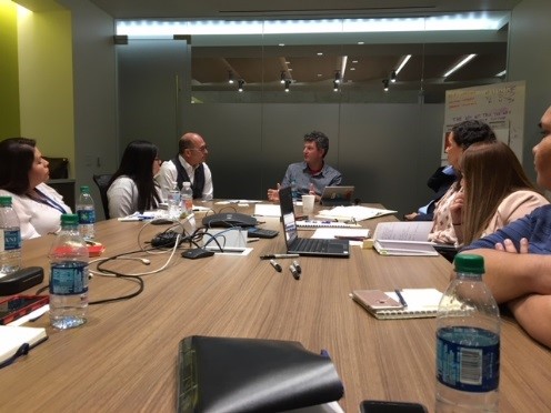 A group of people sit around a table to discuss the 2020 Census.