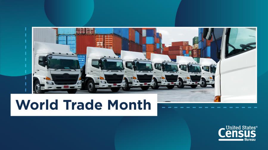 A row of trucks in a port ready to transport goods.