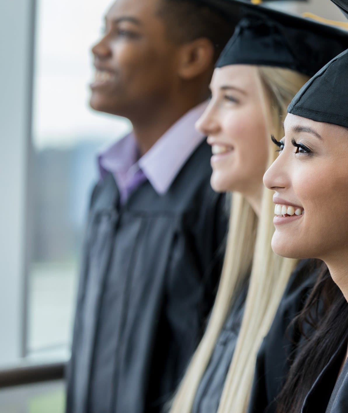 Several students are wearing a cap and gown for graduation.