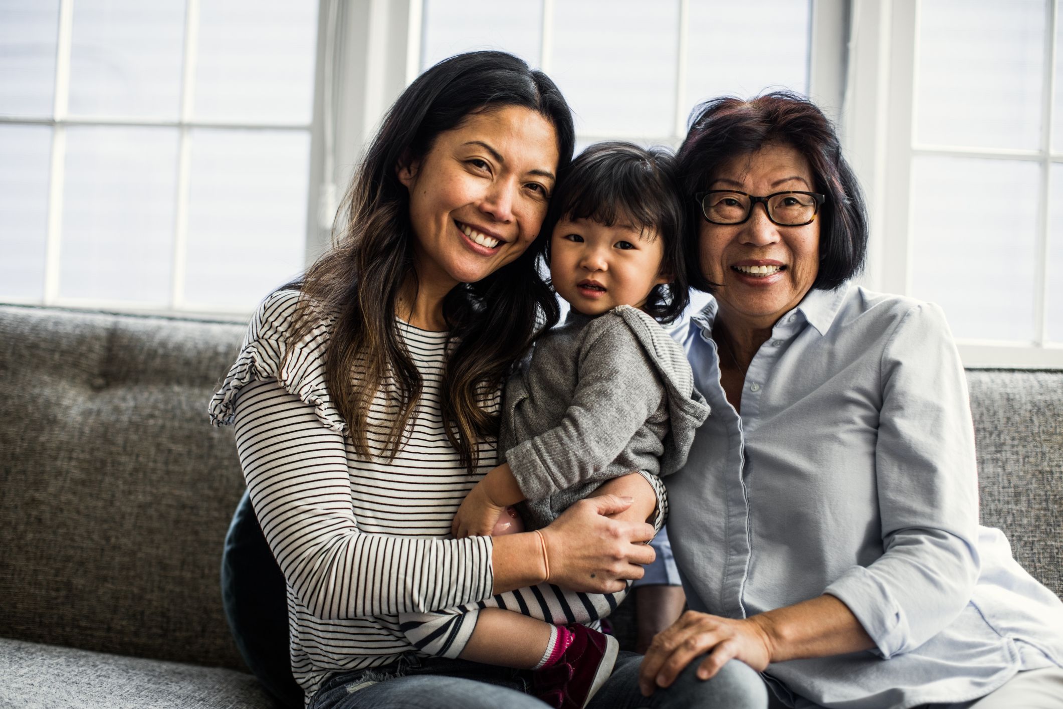 A family is sitting with a child.