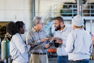 Employees talking in factory