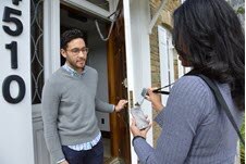 Interviewer with cell phone, conducting an interview